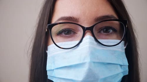 Doctor with Glasses and Protective Mask Poses for Camera