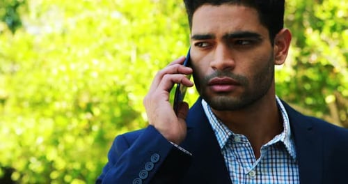 Man Talking on Mobile Phone Outdoors During Day