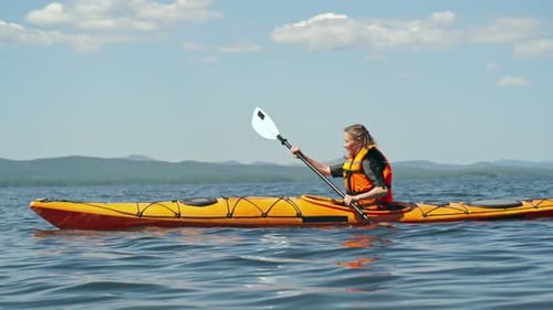 Young Adults Kayaking on a Sunny Day