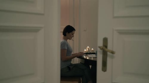 Woman Using Mobile Phone, Candlelit Room At Night