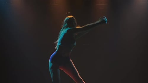 Woman Dancing Sensually in Studio with Stage Lights