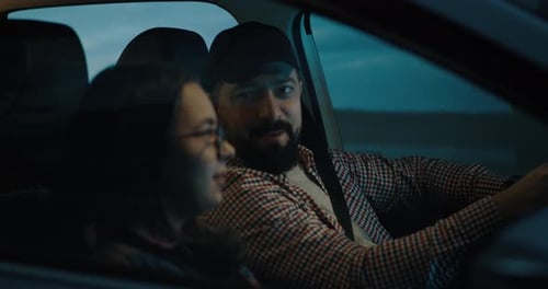 Man and Woman driving car at Night