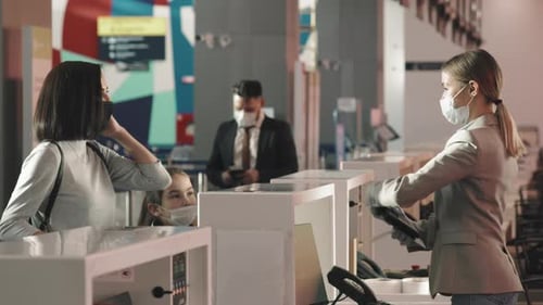 Family Checking In at Airport Counter During Pandemic