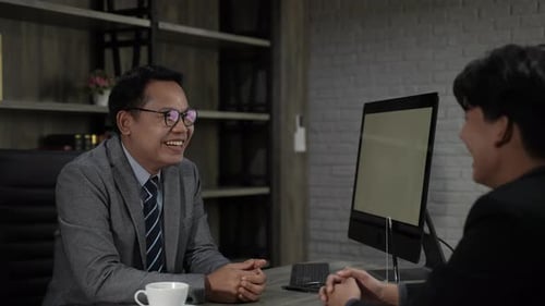 Executives talking to business people at their desks in the office