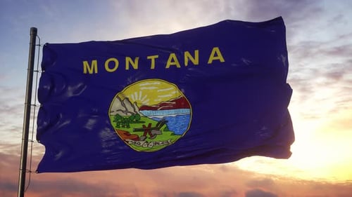 Montana State Flag Waving Proudly Against Sunset Sky