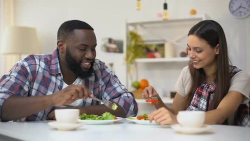 Affectionate Couple Eating Salad Together at Home