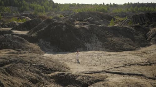 Woman Dances Gracefully in Barren Natural Landscape