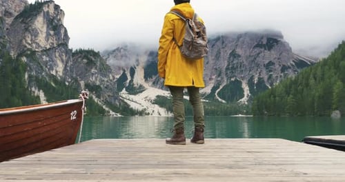 Person Stands on Dock at Mountain Lake