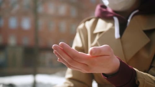 Woman Tourist Using Sanitizer Sanitiser Spray During Walking in the Street
