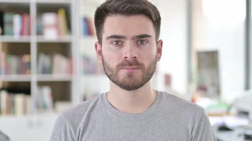 Young Adult Man Looking Straight at Camera