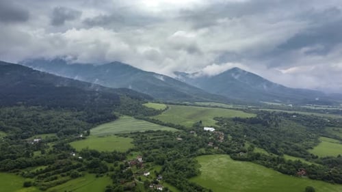 Scenic Aerial View of Green Fields and Mountains