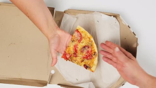 Hand Passing Fresh Slice of Pizza From Above