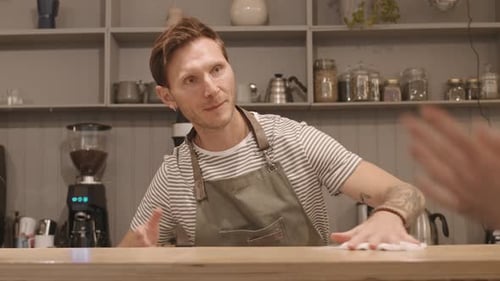 Caucasian Man Polishing Bar Counter