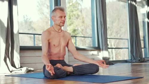 Adult Man Meditating in Lotus Position