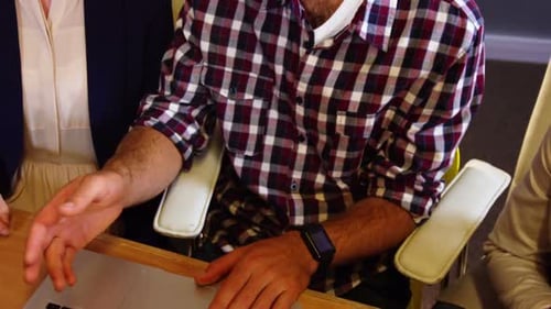 Team Collaborating on Laptop in Modern Office