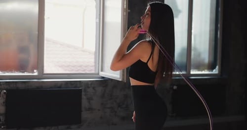 Beautiful Woman Holding Skipping Rope In The Gym