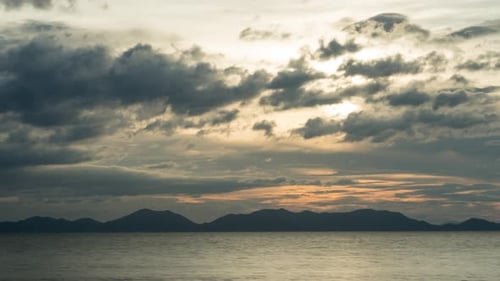 Beautiful sunset timelapse. Sun is setting behind mountains, Ko Lanta, Thailand.