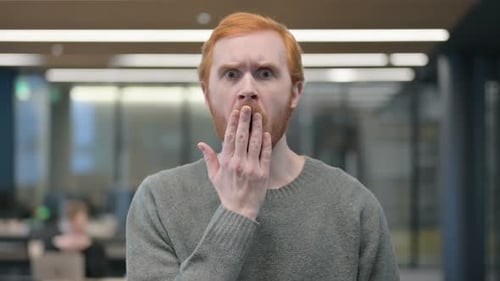Surprised Red Haired Man in Office Setting