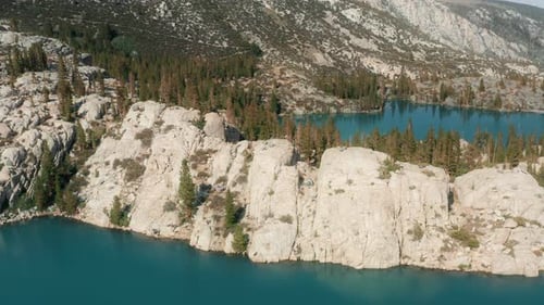 Tranquil Turquoise Lake Surrounded by Mountains and Trees