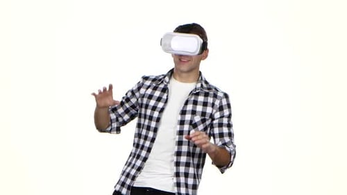 Man Experiencing Virtual Reality Headset on White Background