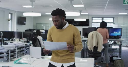 Man reading a document at office