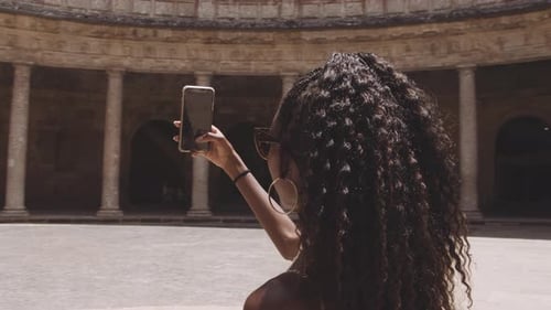 Woman Taking Photo in Historical Courtyard