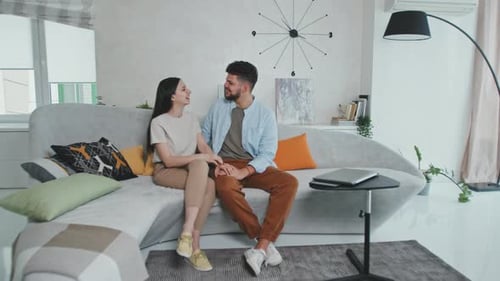 Affectionate Couple Relaxing Together on Modern Couch