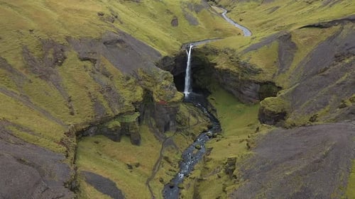 thin waterfall in the mountains of iceland