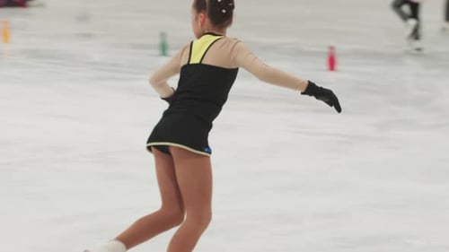Young Girl Figure Skating on Ice Rink