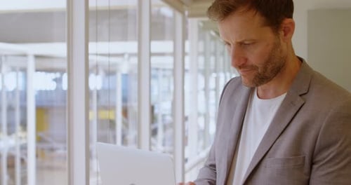 Businessman using laptop in office 4k