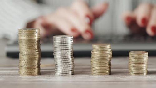 Stacked Coins, Hands Typing at Computer, Finance Concept