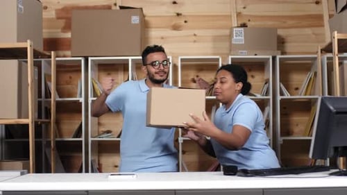 Multiethnic Colleagues Dancing while Processing Mail at Post Office
