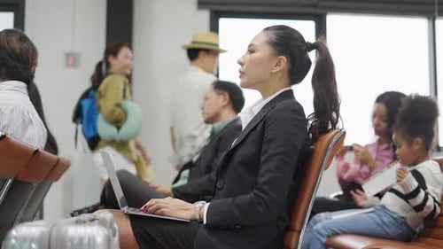 4K Crowd of People waiting for boarding time in airport terminal.