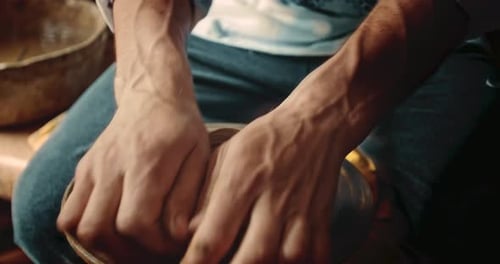 Potter Shaping Clay on Rotating Pottery Wheel