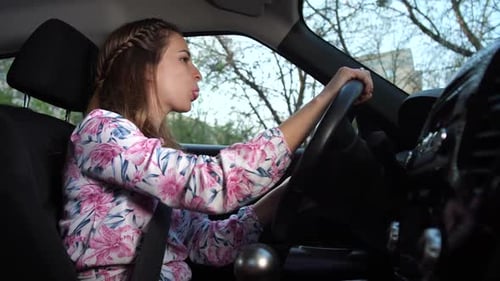 Woman Blowing Bubblegum While Driving Car