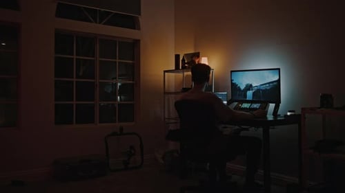 Young Adult Working at Computer at Night