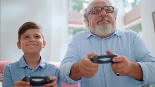 Grandfather and Grandson Playing Video Games Together