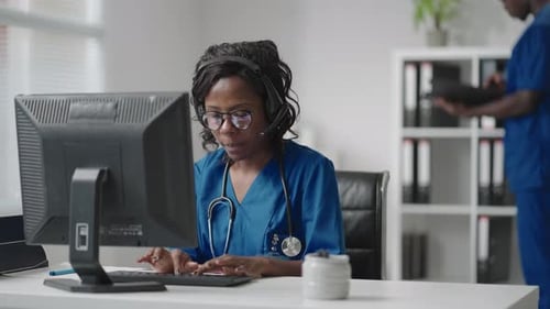 Woman Working in Medical Call Center on Computer
