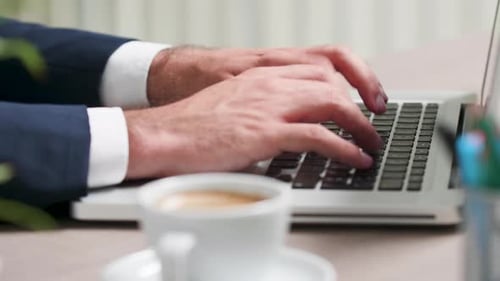 Close Up, Selective Focus, of Male Hands Typing on Keyboard