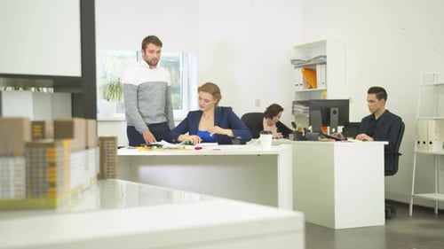 Engineers Work with Drawings of Apartement, Colleagues Work on Computers
