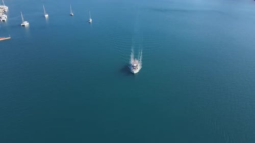 Aerial Drone Tracking Video of Luxury Yacht Cruising in Blue Sea