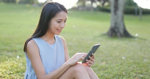 Woman use of smart phone in the park