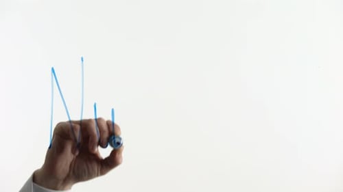 Hand Writes Word Nutrition on Glass Surface