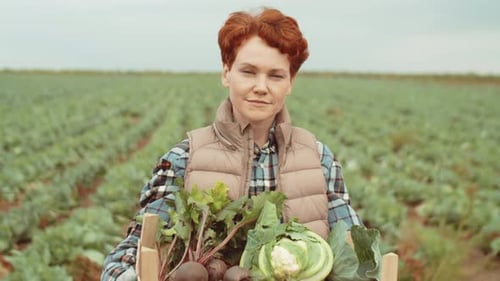 Portrait of Female Farmer with Crate of Fresh Vegetables