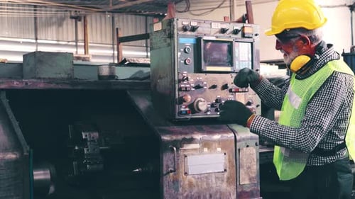 Senior Factory Worker Teach How to Use Machine Equipment in the Factory Workshop