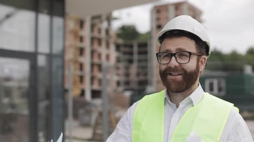 Architect Man Walking on the Construction Site and Analyzing Scheme Project Plan