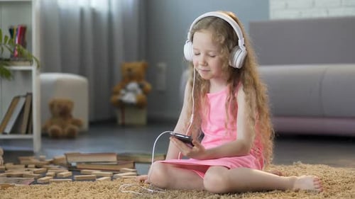 Cute Girl Listening to Music on Headphones