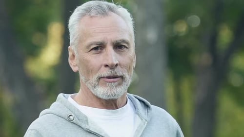 Smiling Senior Man with Gray Hair Outdoors