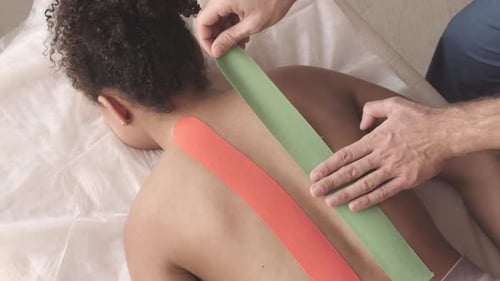 Medical Tape Applied to Young Adult's Back
