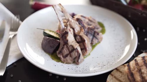Plated Lamb Chops with Vegetables and Green Sauce